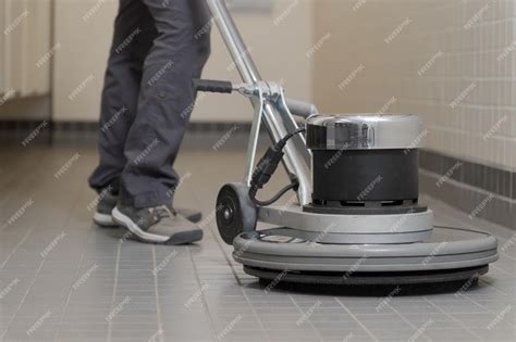 Premium Photo | Closeup of a buffer machine cleaning a ceramic floor
