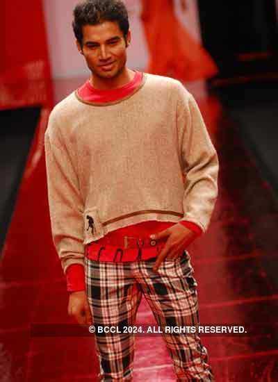 A model walks down the ramp in a creation from designer duo Lecoanet ...