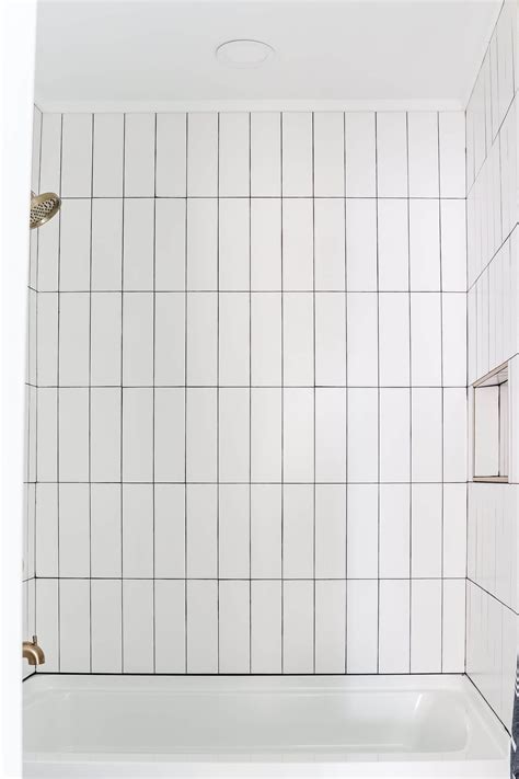 Vertical Stacked Subway Tile Bathroom with Gold Brass Fixtures