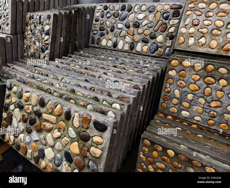 A pile of concrete tiles filled with rocks on top Stock Photo - Alamy