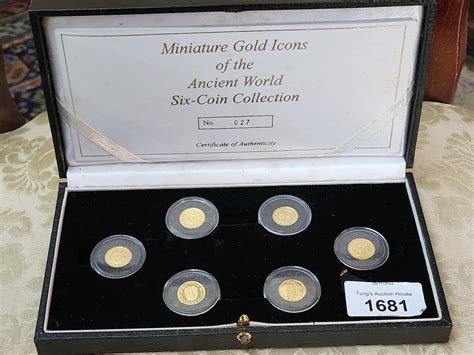 A collection of six miniature gold coins of Icons of the ancient world ...