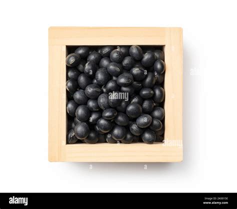Black soybeans in a masu placed against a white background. Black ...