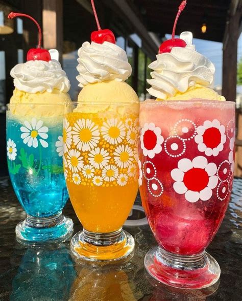 Three Colorful Drinks with Ice Cream and Cherries