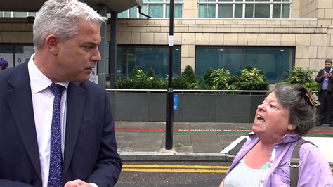 Watch irate woman yell 'people have died & you've done b****r all' at Health Sec as she ...