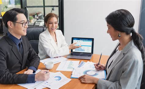 Premium Photo | Asian business people meeting stock brokers looking at graphs indexes and ...