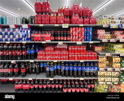 Italy - December 19, 2023: Italian supermarket shelf selling bottles and cans of Coca Cola ...