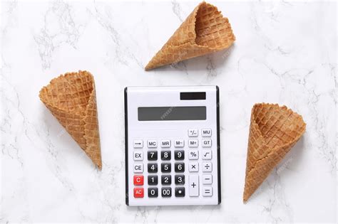 Premium Photo | Empty waffle cones and calculator on marble background ...