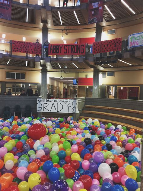 there is a large amount of balloons on the ground in this building that ...