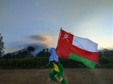 A man is carrying a flag that says international on it | Premium Photo