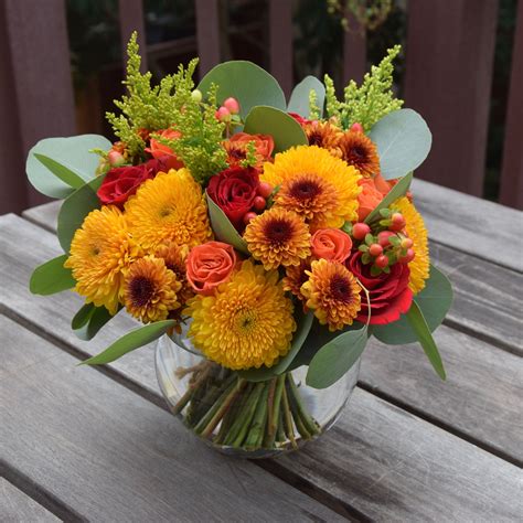 Autumn bouquet of flowers: poms, roses, alstroemerias, salidago ...
