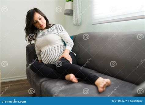 Pregnant Wife Lying on the Sofa Alone with Joint Pains Stock Image ...