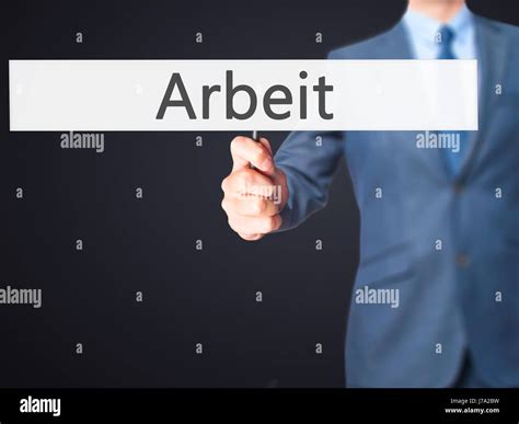 Arbeit (Work in German) - Business man showing sign. Business ...