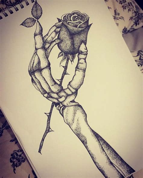 skeleton hand drawing holding rose
