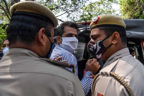 Security personnel detain a protestor during a demonstration outside ...