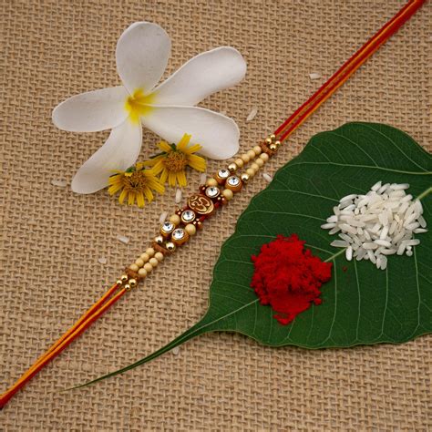 Om Divine Brass Rakhi Set of 2 with Roli Chawal and Raksha Bandhan Gre ...
