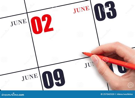 A Hand Holding a Red Pen and Pointing on the Calendar Date June 2. Red ...