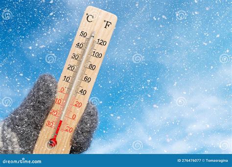 Wooden Celsius and Fahrenheit Scale Thermometer in Hand. Ambient ...