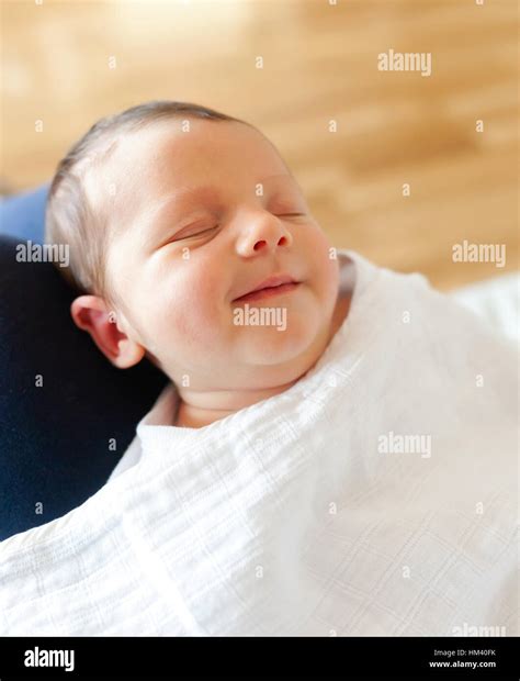Portrait of sleeping newborn baby girl with smile Stock Photo - Alamy