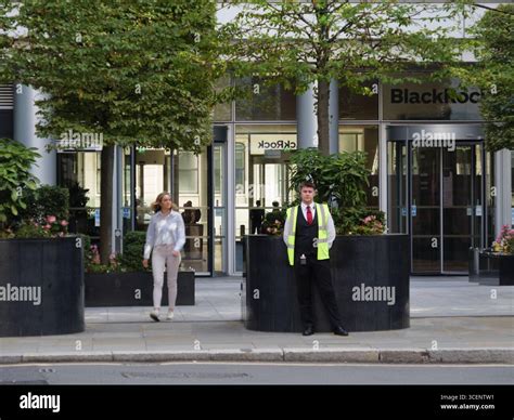 Security guard standing outside the headquarters of BlackRock in the ...