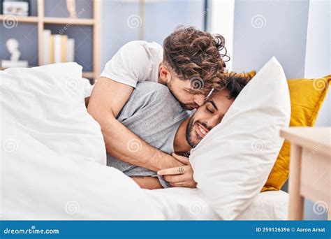 Young Couple Hugging Each Other and Kissing Lying on Bed at Bedrooom ...