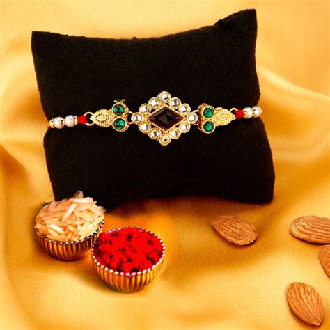 Sukkhi Exclusive Gold Plated Rakhi Combo (Set of 2) with Roli Chawal a ...