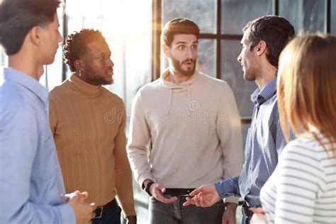 Group of People Standing in a Room Talking 的图像结果