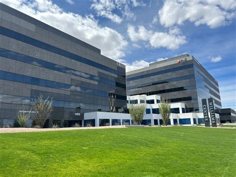 Modern office buildings with reflective glass facades and green lawn, representing managed IT services environments in Pennsylvania.