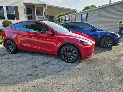 1 week after delivery couldn't be happier 2 x 2023 Model Y Performance red and blue | Tesla ...