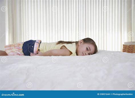 Happy Little Girl Lying In Bed Stock Photography | CartoonDealer.com #33831644