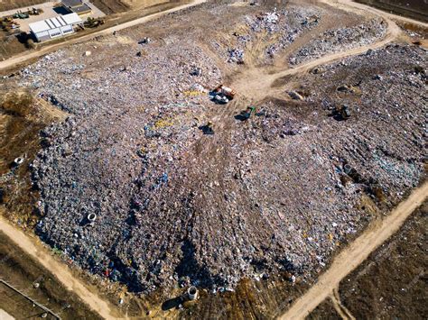 Premium Photo | Aerial view of a vast landfill where bulldozers are ...