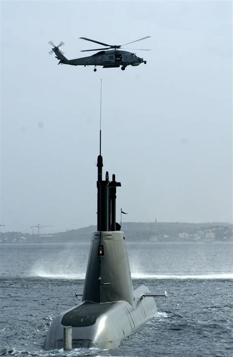Greek SH-60B Sea Hawk flying over a helicopter Type-214 SSK submarine ...