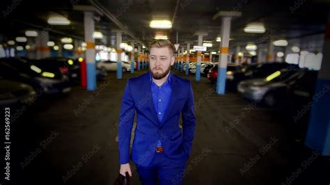 Man in a Business Suit in a Mall Parking Lot 的图像结果