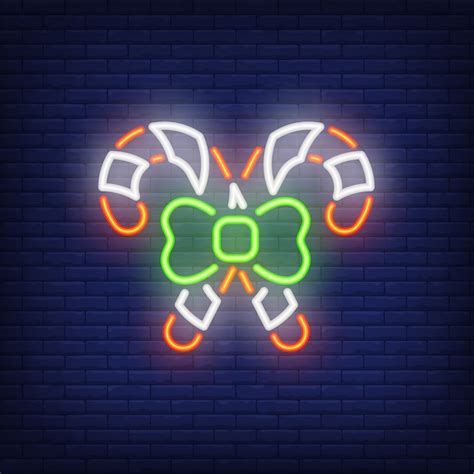 Neon crossed candy canes with bow. festive element. night bright ...