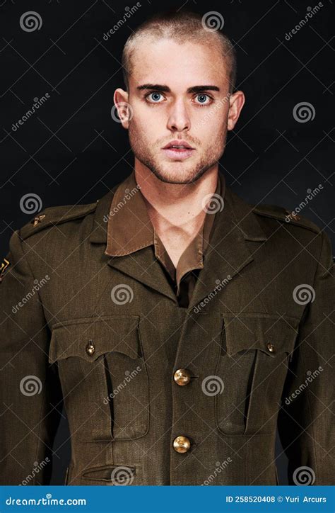 Standing at Attention. Portrait of a Young Man in a Military Uniform ...