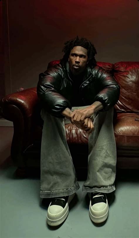 Download Man Seatedon Red Leather Couch Wallpaper | Wallpapers.com