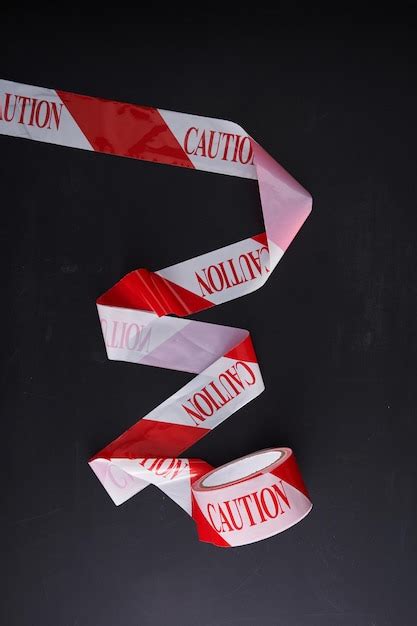 Barricade tape caution tape against chalkboard | Premium Photo