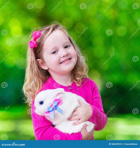 Little Girl Playing with Rabbit Stock Photo - Image of beautiful, child ...