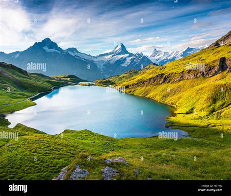 Wetterhorn and Wellhorn peaks over Bachsee lake. Colorful summer scene ...