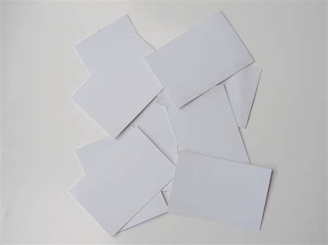 Pile of blank pieces of paper scattered around on white background ...