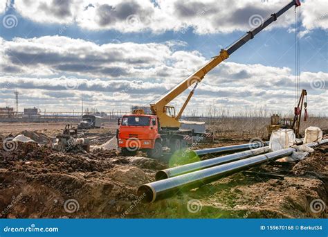 Construction Work on Pipe Laying of Pipeline into the Trench Using a ...