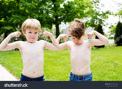 Two Kids Flexing Their Muscles Outside Stock Photo 1876572226 ...