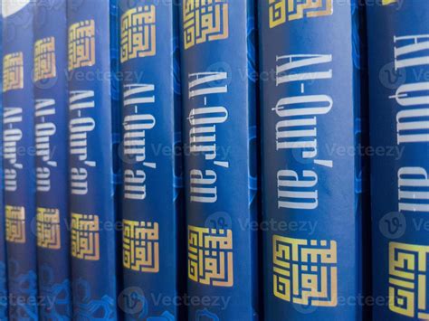 Islamic concept. Holy Quran with written Arabic calligraphy meaning of Al Quran, Arabic word ...