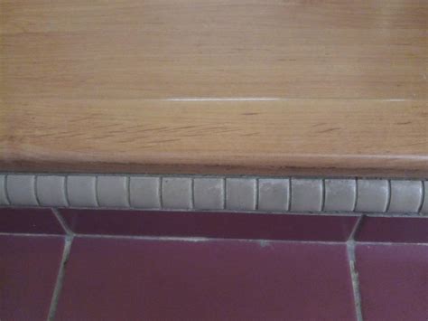 adhesive - How to glue laminate door threshold onto the tiles below ...