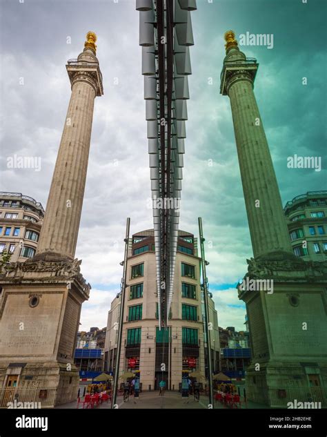 The Great Fire of London Memorial reflecting in the glass of modern buildings around Monument ...