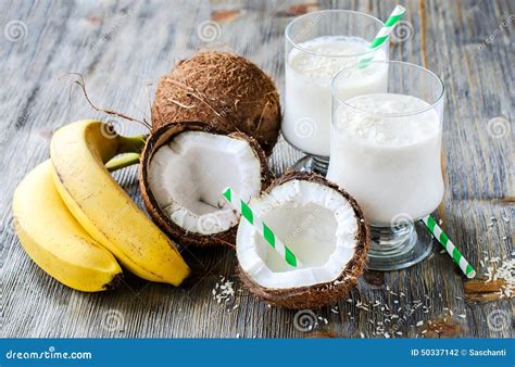 Coconut Milk Smoothie Drink with Bananas on Wooden Background Stock ...