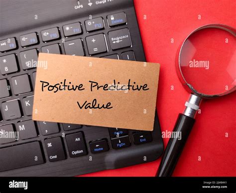 A Magnifying glass and wireless keyboard with the word Positive Predictive Value on red ...