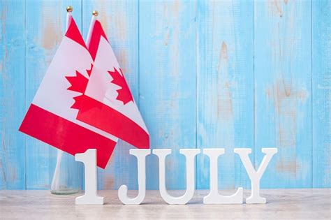Wooden calendar of july 1st with miniature canada flags canada day and ...