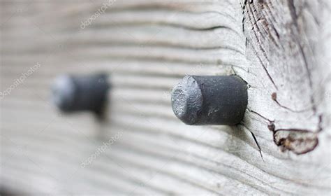 Metal bolts in a wooden banister — Stock Photo © chbaum #43394077