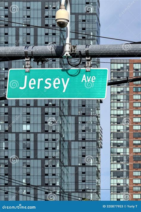 Jersey Avenue Street Sign on Traffic Intersection with Tall Modern ...