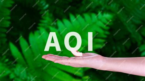 Premium Photo | AQI Abbreviation of air quality index hand holding AQI on nature background ...